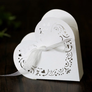 Macro shot of laser-cut heart candy box with elegant white organza ribbon bow