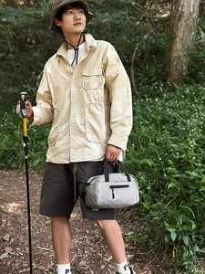 Outdoor nylon sport crossbody bowling bag shown with cargo outfit in forest setting