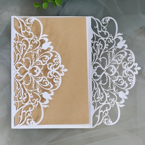 Elegant laser cut wedding invitation with white floral lace sleeve and kraft paper insert
