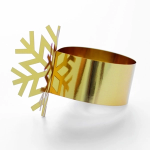Close-up of golden snowflake napkin ring with laser-cut hollow design for holiday table decor