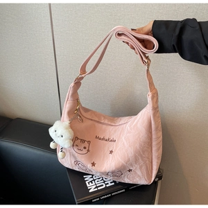 Detail of pink nylon tote bag with cartoon cat print and white cloud plush charm
