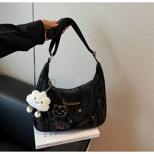 Close-up of black pleated crescent bag with cat embroidery and a plush cloud charm
