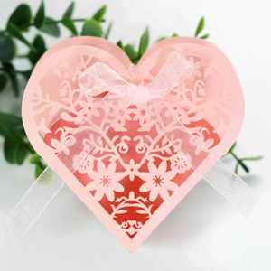 Detailed laser-cut heart candy box with floral patterns and a white organza ribbon bow