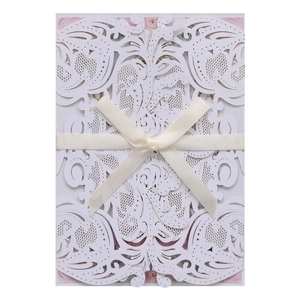Detailed laser-cut floral wedding invitation cover with elegant cream ribbon bow