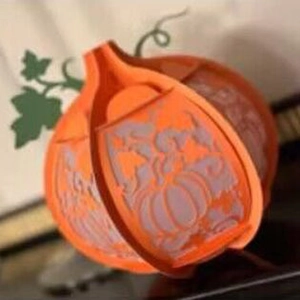 Orange hollow pumpkin paper lantern with 3D laser cut leaf patterns for Halloween decor