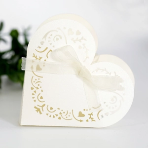 Detailed laser-cut heart and floral patterns on cream paper gift box with ribbon