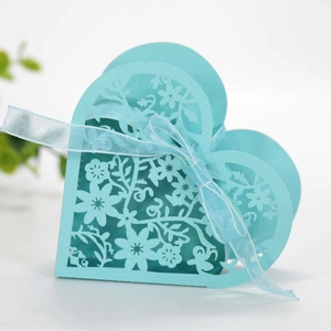 Detailed laser-cut heart candy box in light blue paper with floral vine patterns