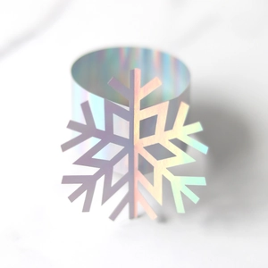 Close-up of laser holographic snowflake napkin ring with iridescent metallic finish