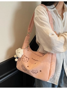 Pink nylon tote bag with cat embroidery and fluffy cloud charm on a light background