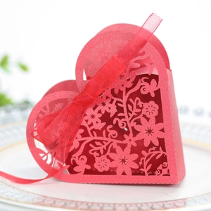 Detailed laser-cut heart candy box in red with elegant floral hollow patterns and ribbon