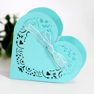 Light blue heart-shaped laser cut wedding candy box with floral patterns and silk ribbon bow