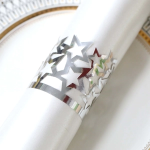 Detailed close-up of hollowed-out star napkin ring with a polished silver mirror finish