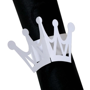 Detailed view of white crown-shaped laser-cut napkin ring on dark background