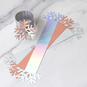 Detail of snowflake napkin rings in iridescent, rose gold and white paper finishes