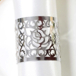 Close-up of a silver hollow rose napkin ring with a polished metallic mirror finish