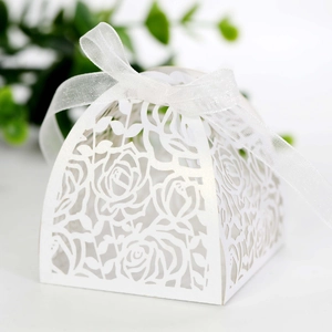 Detail of laser-cut white rose gift box with elegant organza ribbon bow