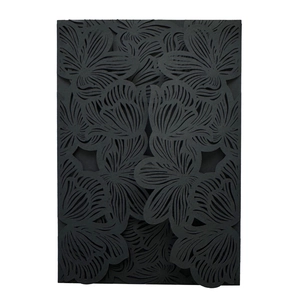 Detailed laser-cut floral pattern on black matte invitation card cover for wedding events