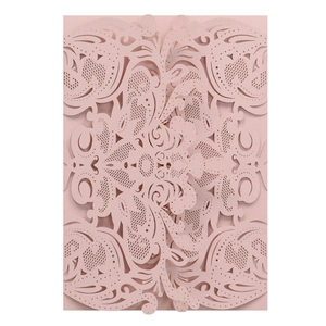 Macro detail of laser-cut floral patterns on elegant pearlized pink wedding invitation