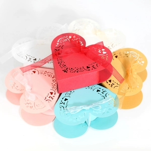 Macro detail of laser-cut heart pattern gift boxes with silk ribbon bows in multiple colors