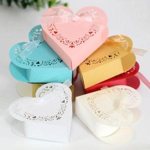 Detail of laser-cut heart candy boxes with organza ribbons in various vibrant colors