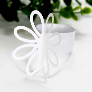 Close-up of a white flower napkin ring with elegant eight-petal daisy hollow-out design
