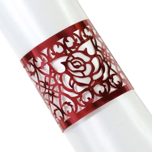 Red laser-cut rose napkin ring with a metallic finish on a white satin cloth