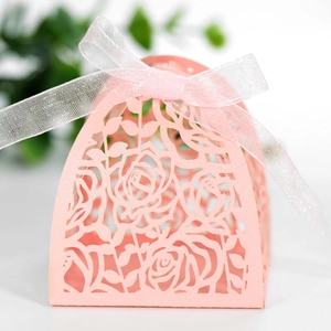 Detailed laser-cut pink hollow gift box with rose patterns and pink ribbon bow