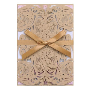 Detailed laser-cut hollow wedding invitation with elegant satin bow and floral inner card