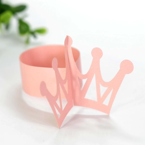 Detail of pink pearlescent crown napkin ring with intricate laser-cut hollow pattern