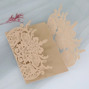 Detailed laser-cut floral pattern on champagne gold elegant wedding invitation cover