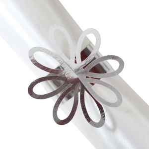 Macro shot of silver petal napkin ring with shiny finish and hollow flower design