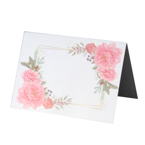 Detail of elegant folding wedding place card with pink rose print and gold line accents
