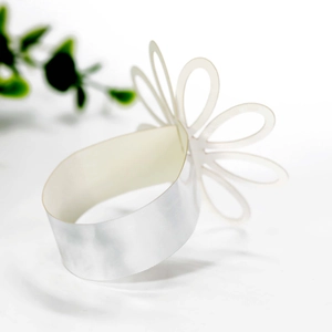 Close-up of elegant hollow petal napkin ring with a shimmering pearlized finish