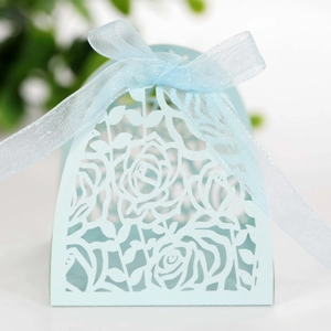 Detailed laser-cut hollow rose pattern on light blue wedding candy gift box with ribbon