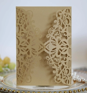 Detailed laser-cut pattern on gold pearlescent invitation card with elegant floral design