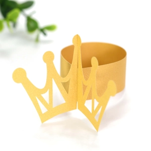 Golden paper crown napkin ring with laser-cut hollow design for festive table decoration