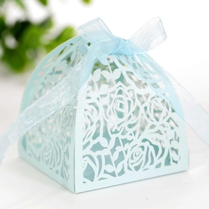 Close-up of laser-cut rose hollow pattern on light blue favor box with ribbon