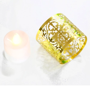 Detailed view of hollow floral pattern on a gold metallic festive tea light holder