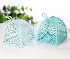 Close-up of laser-cut hollow rose candy boxes with matching organza ribbon bows