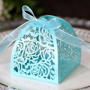 Elegant light blue laser-cut candy box with pearl paper and floral ribbon bow detail