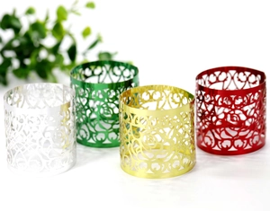 Detailed macro view of metallic rose hollow napkin rings in silver gold and red