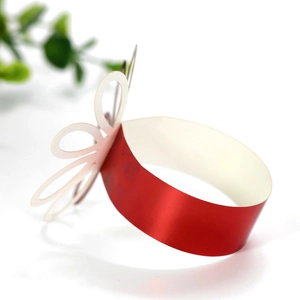 Detail of red reflective napkin ring with delicate white hollowed-out butterfly decor