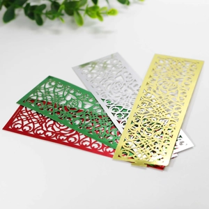 Detail of laser-cut rose napkins rings in gold, silver, red and green metallic finishes