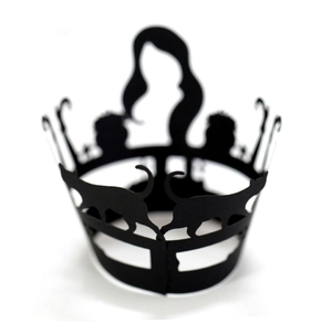 Detail of laser-cut black crown cupcake wrapper featuring elegant silhouette patterns