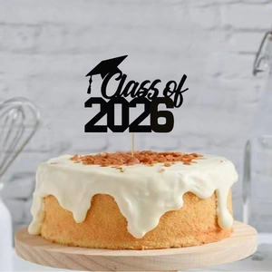 Class of 2026 graduation cake topper with black mortarboard hat on white cream cake