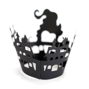 Detailed laser-cut black castle silhouettes on Halloween cupcake wrappers