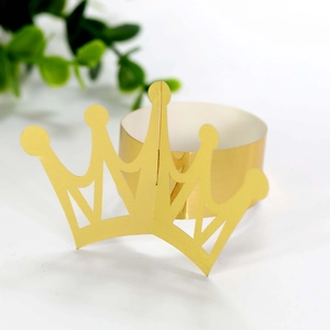 Detail of laser-cut gold crown napkin ring with adjustable slot for party decor