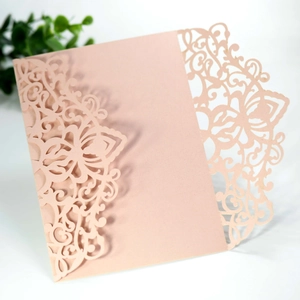 Detailed laser-cut floral pattern on elegant light pink peach wedding invitation cover