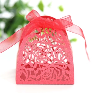 Detail of red laser-cut rose gift box with elegant organza ribbon bow for chocolates