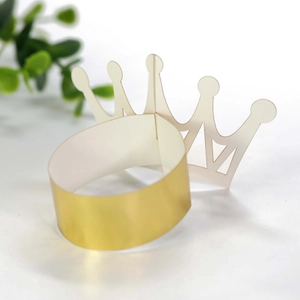 Macro view of golden reflective mirror paper crown napkin ring for wedding parties